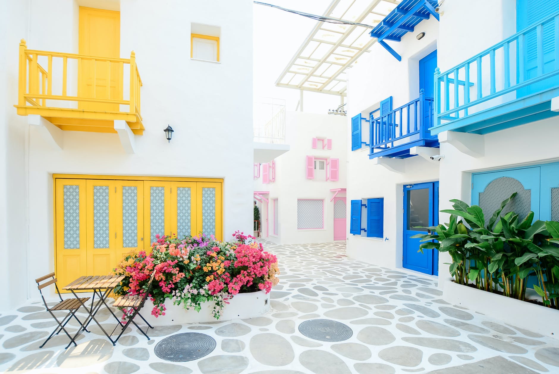 architectural photography of three pink blue and yellow buildings